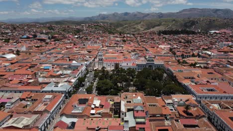 Aerial-pulls-back-from-Main-Square-in-mountain-city-of-Sucre,-Bolivia
