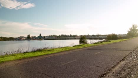 Biker-riding-on-path-into-the-sunset-on-the-river