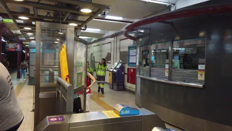 Senior-Citizen-Woman-Buys-Ticket-and-Enters-Underground-Metro-Station-Argentina-Buenos-Aires-City,-Vintage-Architecture