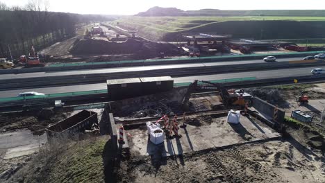 Pull-out-drone-shot-of-a-highway-and-construction-site