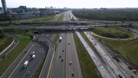 City-highway-interchange-during-morning-rush-hour-with-transport-trucks-and-automobiles