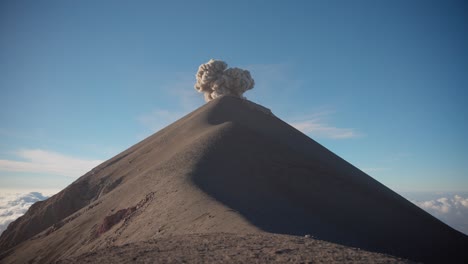 Fuego-Volcano's-explosive-eruption-at-sunrise,-rocks-thrown,-ash-plume-rising,-no-people