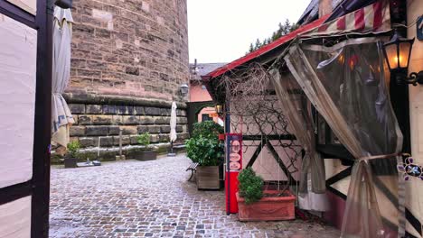 Light-snowfall-in-the-charming-craftsman-market-before-the-shops-open-in-Nuremberg,-Germany