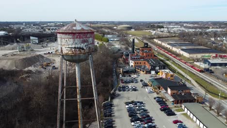 Drone-shot-of-the-water-tower-at-the-Pepper-Distillery-District-in-Lexington,-Kentucky