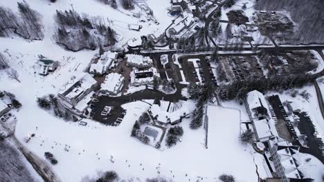 Topdown-view-of-ski-lifts-moving-skiers-and-snowboarders-up-the-mountain-on-snowy-slopes-at-a-winter-resort-in-the-Appalachian-foothills-of-west-Massachusetts