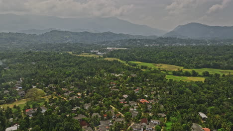 Matale-Sri-Lanka-Aerial-v3-drone-flyover-picturesque-residential-suburb-of-Kotuwegedara,-capturing-the-mountainous-landscape-and-vast-stretches-of-lush-farmland---Shot-with-Mavic-3-Cine---April-2023