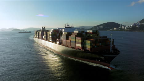 Container-ship-approaching-with-urban-archipelago-in-the-background