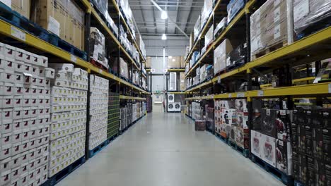 Costco-Warehouse-walkway-aisle-with-tall-racking-of-white-goods-on-pallets-POV