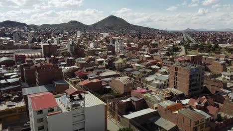 Aerial-flyover-building-rooftops-in-altiplano-city-of-Oruro,-Bolivia