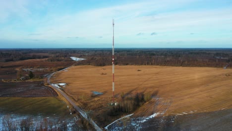 Aerial-view-of-telecommunication-tower-in-wide-landscape-with-farmland