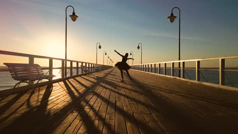Ballet-dancer-practicing-in-beach-pier-at-sunrise