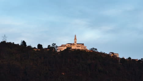 Aerial-view-rising-toward-the-Monserrate-Sanctuary,-sunset-in-Bogota,-Colombia