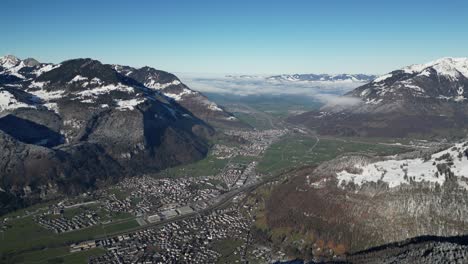 Fronalpstock-Glarus-Switzerland-view-of-amazing-village-in-Alps-with-clouds-low-between-mountains