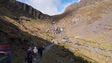 hill-walkers-on-trail-at-beauty-spot-Mahon-falls-Comeragh-Mountains-Waterford-Ireland