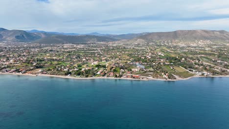 Flying-towards-the-coastline-with-houses-and-agricultural-land