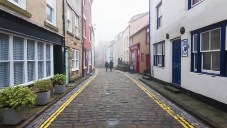 People-walking-along-the-quite-streets-of-Staithes-a-sleepy-fishing-village-on-the-Yorkshire-coast-of-England