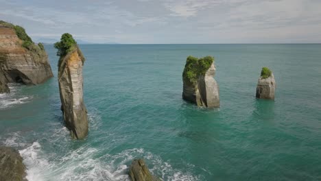 Three-Sisters-rock-formation-formed-by-sea-erosion-in-New-Zealand