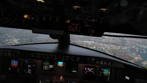 Pilot-POV-aerial-night-view-of-Valencia-Harbor,-Spain,-shot-from-an-airplane-cockpit-during-the-approach-to-the-airport