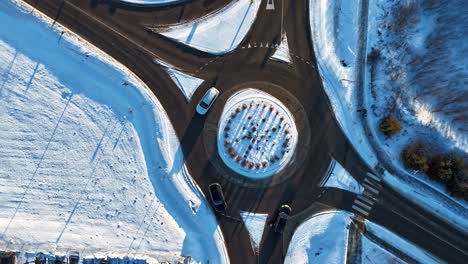 Traffic-flow-at-roundabouts-in-the-city-in-winter,-Silute,-Lithuania,-Germany