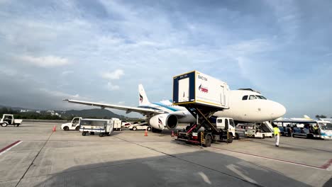 Bangkok-airline-Jets-offloading-passengers-along-the-runway-of-Koh-Samui-Island-Airport,-View-from-shuttle-vehicle