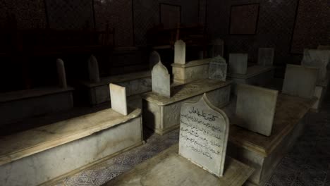 Islamic-Inscripted-stone-Tombs-within-the-dark-Tourbet-el-Bey-Muslim-mausoleum