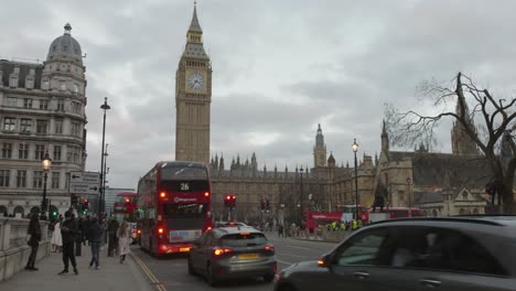 Traffic-in-Westminster-district,-typical-red-double-decker-buses,-Big-Ben-in-the-background