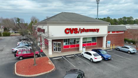 Car-leaving-parking-lot-in-front-of-CVS-pharmacy-in-USA