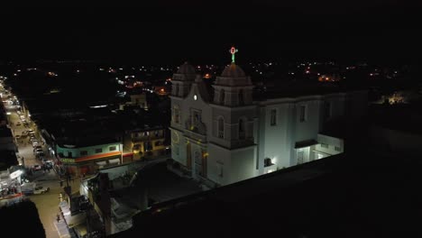 Saint-Mary-of-Guadalupe-temple-in-Tecalitlan-illuminated-at-night,-entry-and-court-from-above