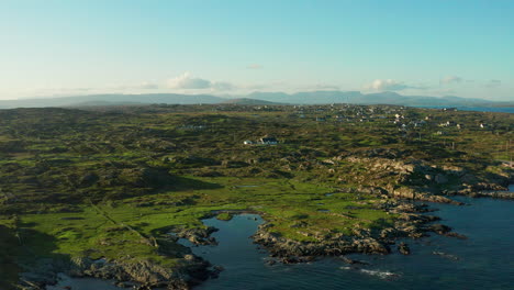 Embark-on-a-visual-journey-through-the-mesmerizing-landscapes-of-Connemara,-Galway,-Ireland,-with-a-parallax-drone-shot-capturing-the-vivid-green-scenery