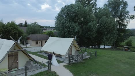 Romantic-couple-holding-hands-and-walking-towards-wedding-venue-for-marriage