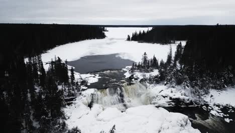 Slow-4K-Drone-In-Shot-of-environment-nature-Tourism-Travel-Landmark-frozen-winter-Pisew-Kwasitchewan-Falls-Waterfall-Provincial-Park-near-Thompson-Manitoba-Northern-Arctic-Canada-Landscape