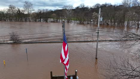 American-flag-waving-over-flooded-park-in-USA