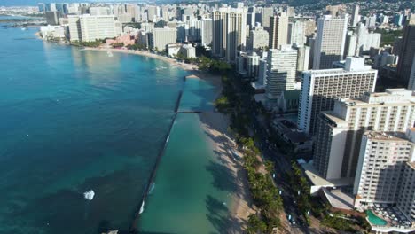 Pullback-Drone-Reveal-Waikiki-Beach-and-City-Skyline-Highrise-Buildings