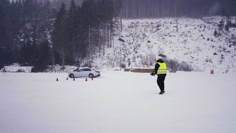 Person-wear-green-reflective-safety-jacket-and-film-winter-drift-event