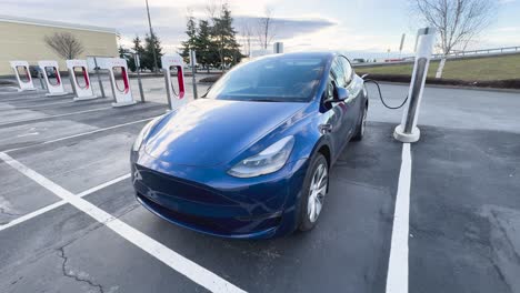 Blue-Tesla-Model-Y-charging-at-a-Tesla-Supercharger