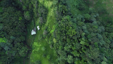 Shack-in-the-woods,-aerial-downwards-view