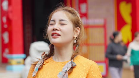 Close-up-of-an-Asian-girl-in-national-costume-walking-to-visit-a-pagoda