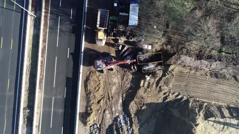 Drone-shot-from-above-with-a-highway-and-construction-site