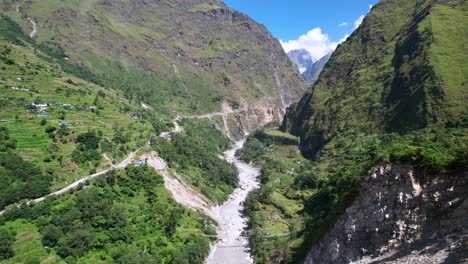 Flying-Along-Lush-Kali-Gandaki-Gorge,-Over-Kali-Gandaki-River-Towards-Rupse-Falls-in-Central-Nepal-on-Sunny-Summer-Day