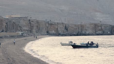 View-of-traditional-fisher-boat-anchored-on-the-beach,-khasab-beach-at-sunset