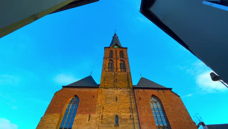 Front-facade-of-Catholic-church-in-German-village-Straelen-in-sunlight-with-blue-sky