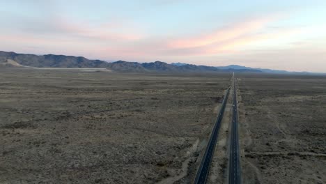 Highway-93-in-Arizona-with-desert-landscape-and-mountains-in-the-distance-with-drone-video-moving-in