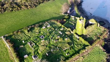 Establishing-aerial-drone-shot-of-the-Aughadown-Graveyard-along-the-River-llen-in-West-Cork