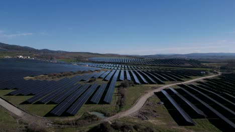 Expansive-solar-farm-in-rural-Portugal-landscape---aerial-descend