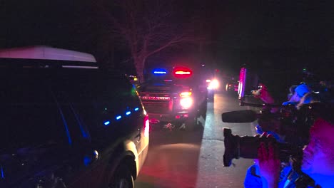 Police-vehicles-arriving-at-scene-of-mass-shooting-surrounded-by-press-in-Lewiston,-USA