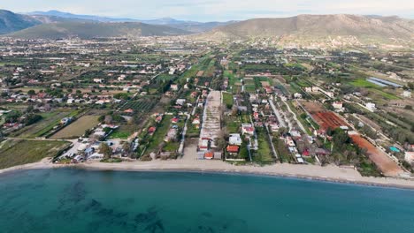 Flying-around-the-coastline-in-Marathon,-Greece