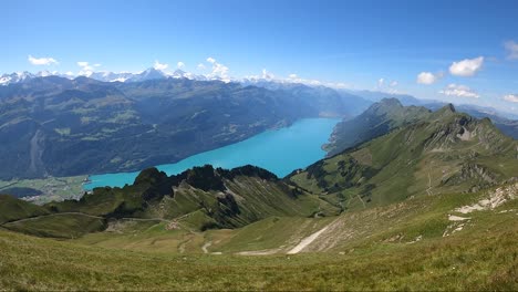 Tourist-hike-at-Brienz-Lake-grasslands,-mountains,-valleys-and-meadows-in-Switzerland