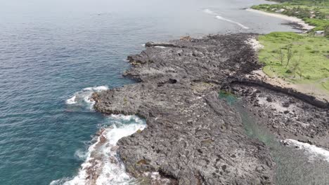 Drone-view,-low-altitude-flyover-forward-movement-above-the-rocks-of-Pointe-au-Sel-in-Saint-Leu,-Reunion-Island