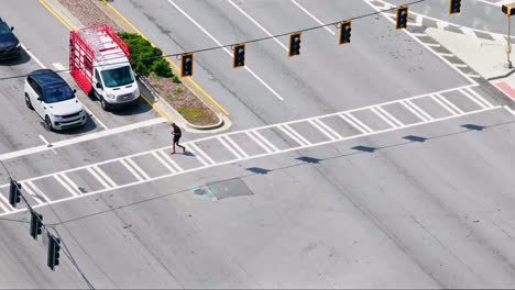 Male-Pedestrian-crossing-road-with-waiting-cars-at-junction