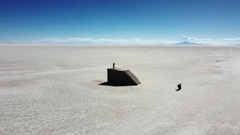 Man-stands-atop-staircase-made-of-salt-on-Uyuni-Salt-Flat-in-Bolivia